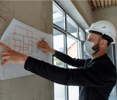 Specialty contractors checking a building plan